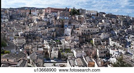 Stock Image - Aerial panorama of ancient town of Matera with tufa houses, sunny spring afternoon with blue sky, Puglia, Southern Italy,. Fotosearch