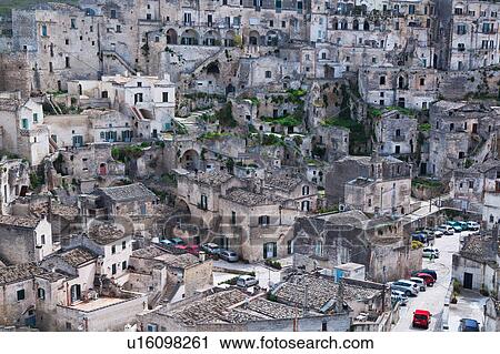 Stock Image - Aerial view of ancient town of Matera with tufa houses, sunny spring morning, Puglia, Southern Italy. Fotosearch