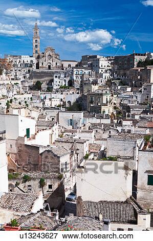 Aerial view of ancient town of Matera with tufa houses, and Duomo on hill beyond, sunny spring afternoon with blue sky, Puglia, Southern Italy, View Large Photo Image Stock Photo - Aerial view of ancient town of Matera with tufa houses, and Duomo on hill beyond, sunny spring afternoon with blue sky, Puglia, Southern Italy,. Fotosearch