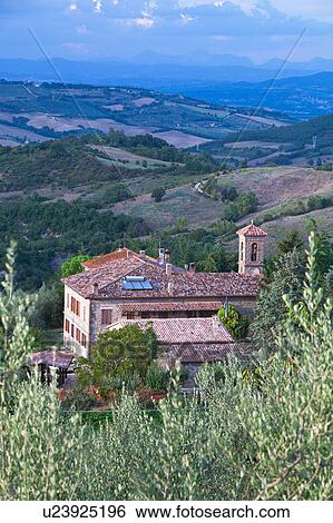 Aerial view of borgo farmhouse with tiled rooftops and church bell tower, fields, hills and distant mountains beyond, sunny late afternoon, Umbria, Italy View Large Photo Image Stock Photograph - Aerial view of borgo farmhouse with tiled rooftops and church bell tower, fields, hills and distant mountains beyond, sunny late afternoon, Umbria, Italy. Fotosearch