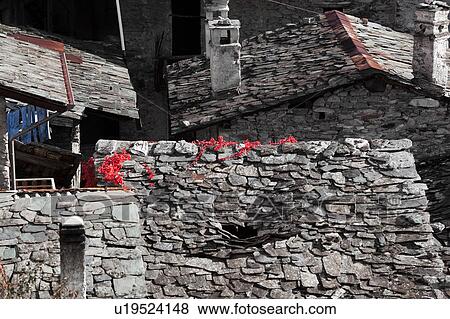 Aerial view of village slate roofs, in various states of disrepair, and autumn colours of red ivy vine, Lombardy, Italy View Large Photo Image Stock Photo - Aerial view of village slate roofs, in various states of disrepair, and autumn colours of red ivy vine, Lombardy, Italy. Fotosearch
