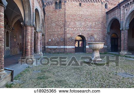 Stock Photography - Church of Santo Stefano, complex of seven churches, showing Cortile di Pilato (Pilate's courtyard) with highly decorated tiled porticos and ancient stone baptismal font, Bologna, Italy. Fotosearch