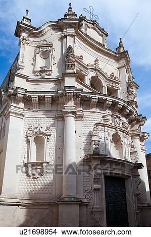 Picture - Close up of facade, church of San Matteo, Baroque ornamentation and doorway, sunny spring morning with blue sky, Lecce, Salento, Puglia, Southern Italy. Fotosearch