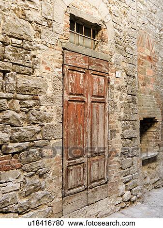 Close up of old wooden door, red peeling paint, and medieval wall of house with traditional combination of red brick and local grey stone, cobbled street. View Large Photo Image Stock Image - Close up of old wooden door, red peeling paint, and medieval wall of house with traditional combination of red brick and local grey stone, cobbled street.. Fotosearch