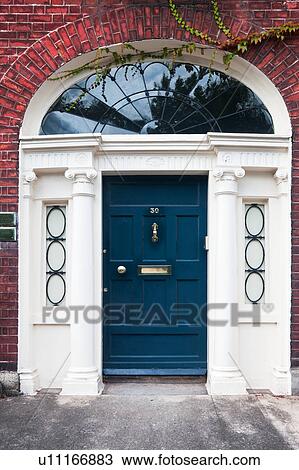Close up view of traditional Georgian red brick house with ornate arched blue doorway, Dublin, Southern Ireland View Large Photo Image Stock Image - Close up view of traditional Georgian red brick house with ornate arched blue doorway, Dublin, Southern Ireland. Fotosearch