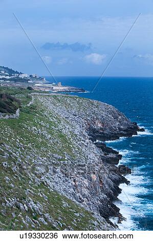 Coastline on sunny afternoon with storm threatened, rocky cliffs, row of 16th century defense towers along shoreline, Santa Cesarea Terme,, Salento, Puglia, Southern Italy View Large Photo Image Stock Photograph - Coastline on sunny afternoon with storm threatened, rocky cliffs, row of 16th century defense towers along shoreline, Santa Cesarea Terme,, Salento, Puglia, Southern Italy. Fotosearch