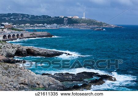 Coastline on sunny afternoon with storm threatened, rocky cliffs, lighthouse and Basilica of Santa Maria di Leuca, Salento, Puglia, Southern Italy View Large Photo Image Stock Photography - Coastline on sunny afternoon with storm threatened, rocky cliffs, lighthouse and Basilica of Santa Maria di Leuca, Salento, Puglia, Southern Italy. Fotosearch