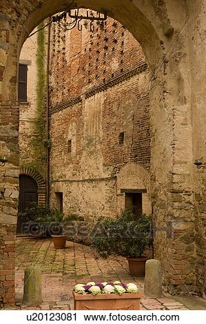 Stock Image - Courtyard entrance of Castello, Sant'Appollinare on overcast winter day, showing beauty of ancient brickwork and colours. Fotosearch