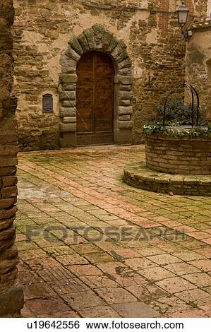 Stock Photograph - Courtyard interior of Castello, Sant'Appollinare on overcast winter day, showing beauty of ancient brickwork and colours. Fotosearch