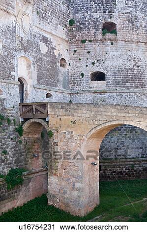 Detail of 16th century castle, with bridge leading across grassed moat to stone wall and round tower, Otranto, Salento, Puglia, Southern Italy View Large Photo Image Stock Image - Detail of 16th century castle, with bridge leading across grassed moat to stone wall and round tower, Otranto, Salento, Puglia, Southern Italy. Fotosearch