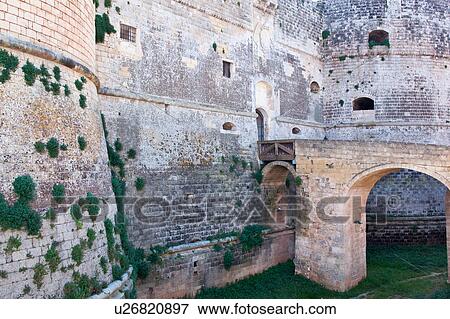 Detail of 16th century castle, with bridge leading across grassed moat to stone wall and round tower, Otranto, Salento, Puglia, Southern Italy View Large Photo Image Stock Photo - Detail of 16th century castle, with bridge leading across grassed moat to stone wall and round tower, Otranto, Salento, Puglia, Southern Italy. Fotosearch