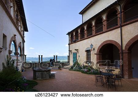 Detail of courtyard of Italian Renaissance convent, with arched windows and balustrade, brick and stucco, with couple viewing landscape beyond, on sunny spring morning, Todi, Umbria View Large Photo Image Stock Photo - Detail of courtyard of Italian Renaissance convent, with arched windows and balustrade, brick and stucco, with couple viewing landscape beyond, on sunny spring morning, Todi, Umbria. Fotosearch
