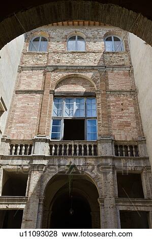 Detail of inner courtyard of Italian Renaissance palazzo, with arched windows and balustrade, brick and stucco, Todi, Umbria View Large Photo Image Stock Photo - Detail of inner courtyard of Italian Renaissance palazzo, with arched windows and balustrade, brick and stucco, Todi, Umbria. Fotosearch