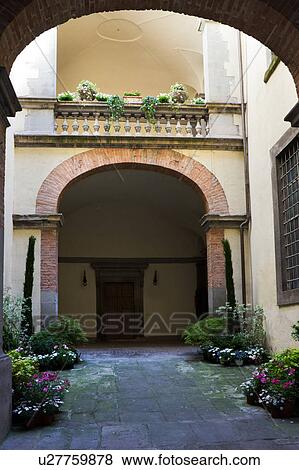Detail of inner courtyard of Italian Renaissance palazzo, decorated with flowers, with arched windows and balustrade, brick and stucco, Todi, Umbria View Large Photo Image Stock Photo - Detail of inner courtyard of Italian Renaissance palazzo, decorated with flowers, with arched windows and balustrade, brick and stucco, Todi, Umbria. Fotosearch