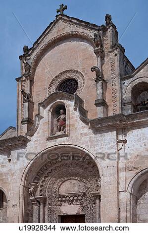 Detail of Romanesque facade of church of San Giovanni, with typical stone carved scroll work and statues, sunny spring afternoon, Matera, Puglia, Southern Italy View Large Photo Image Picture - Detail of Romanesque facade of church of San Giovanni, with typical stone carved scroll work and statues, sunny spring afternoon, Matera, Puglia, Southern Italy. Fotosearch