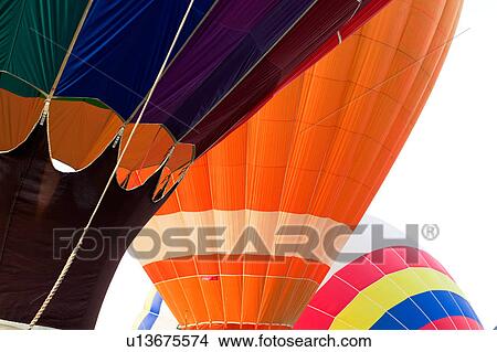 Picture - Detail of three balloons - orange balloon with multicoloured balloon, overlapping on each side. Fotosearch