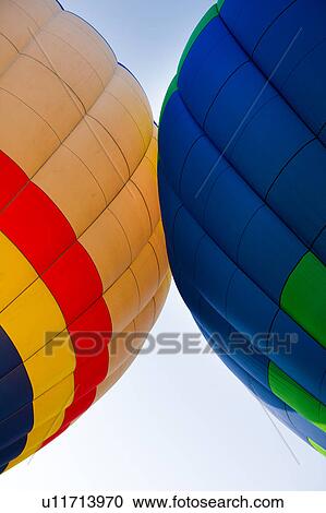 Detail of two brightly coloured hot air balloons "kissing", with blue sky beyond View Large Photo Image Stock Image - Detail of two brightly coloured hot air balloons "kissing", with blue sky beyond. Fotosearch
