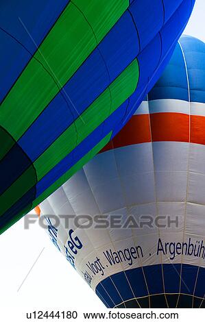 Detail of two brightly coloured hot air balloons "kissing", with blue sky beyond View Large Photo Image Stock Image - Detail of two brightly coloured hot air balloons "kissing", with blue sky beyond. Fotosearch