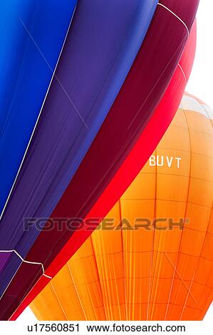 Detail of two brightly coloured hot air balloons "kissing", with blue sky beyond overlapping balloons in flight View Large Photo Image Stock Image - Detail of two brightly coloured hot air balloons "kissing", with blue sky beyond overlapping balloons in flight. Fotosearch
