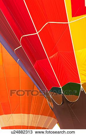 Detail of two hot air balloons overlapping: multicoloured red and purple balloon in front, orange balloon behind View Large Photo Image Stock Image - Detail of two hot air balloons overlapping: multicoloured red and purple balloon in front, orange balloon behind. Fotosearch