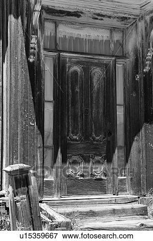 Stock Photo - Detail of wooden house with wooden frame door, desaturated image, Bodie pioneer village, California. Fotosearch
