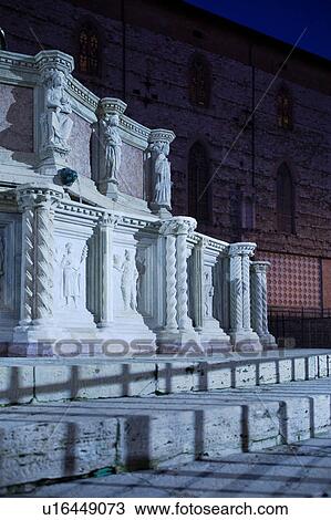 Detail, showing sculpted figures, of Fontana Maggiore (Great Fountain) in Piazza IV Novembre, Perugia with facade of Duomo behind, at dusk, Umbria, Italy View Large Photo Image Stock Image - Detail, showing sculpted figures, of Fontana Maggiore (Great Fountain) in Piazza IV Novembre, Perugia with facade of Duomo behind, at dusk, Umbria, Italy. Fotosearch
