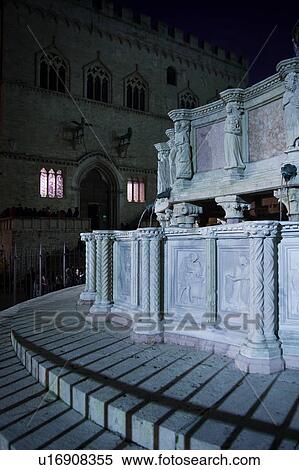 Detail, showing sculpted figures, of Fontana Maggiore (Great Fountain) in Piazza IV Novembre, Perugia with facade of Palazzo dei Priori (Town Hall) behind, at dusk, Umbria, Italy View Large Photo Image Stock Photography - Detail, showing sculpted figures, of Fontana Maggiore (Great Fountain) in Piazza IV Novembre, Perugia with facade of Palazzo dei Priori (Town Hall) behind, at dusk, Umbria, Italy. Fotosearch