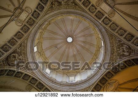 Stock Image - Detail view of interior of cupola of Tempio di Bramante, showing central dome and surrounding carved stone arches, Todi, Umbria, Italy. Fotosearch