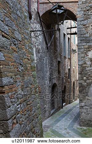Detail view of medieval street, with stone walls, arch above, and paved curved cobblestone street, Todi, Umbria, Italy View Large Photo Image Stock Photo - Detail view of medieval street, with stone walls, arch above, and paved curved cobblestone street, Todi, Umbria, Italy. Fotosearch