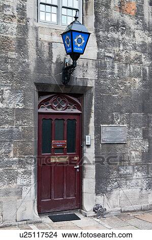 Detail view of south facade of Dublin Castle with wooden and glass door of Garda (police) museum, grey stone wall of Norman Record Tower, Dublin, Southern Ireland View Large Photo Image Picture - Detail view of south facade of Dublin Castle with wooden and glass door of Garda (police) museum, grey stone wall of Norman Record Tower, Dublin, Southern Ireland. Fotosearch