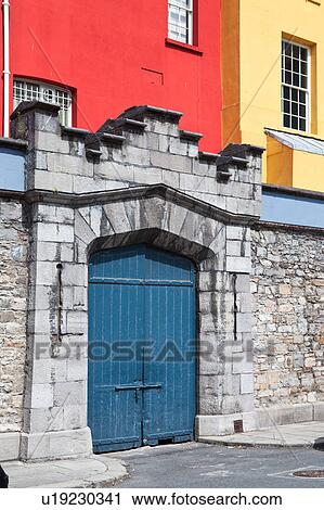 Stock Image - Detail view of south facade of Dublin Castle, with different areas painted green, blue, red, and yellow against grey Norman stone of original fortifications, Dublin, Southern Ireland. Fotosearch