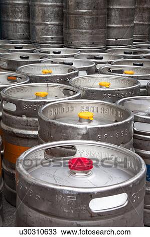 Stock Image - Early morning in Dublin: close up view of empty metal beer kegs lined up on street Dublin, Southern Ireland. Fotosearch