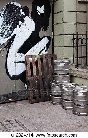 Early morning in Dublin, with empty metal beer kegs lined up outside doorway, with stunning black and white graffiti angel painted on door, Dublin, Southern Ireland View Large Photo Image Picture - Early morning in Dublin, with empty metal beer kegs lined up outside doorway, with stunning black and white graffiti angel painted on door, Dublin, Southern Ireland. Fotosearch