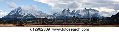 Early morning panorama view of snow covered Los Cuernos, and mountain range, Torres del Paine, with dramatic clouds, beech trees in full autumn colours, Southern Chile, Patagonia View Large Photo Image Stock Photo - Early morning panorama view of snow covered Los Cuernos, and mountain range, Torres del Paine, with dramatic clouds, beech trees in full autumn colours, Southern Chile, Patagonia. Fotosearch