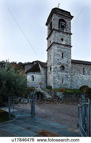 Exterior view of apse, bell tower and side of Abbey of Piona, Lake Como, Northern Italy from churchyard and gardens in early morning pale sunlight, with blue sky View Large Photo Image Stock Photograph - Exterior view of apse, bell tower and side of Abbey of Piona, Lake Como, Northern Italy from churchyard and gardens in early morning pale sunlight, with blue sky. Fotosearch