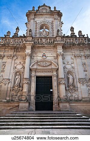 Picture - Facade of Duomo (cathedral), exuberant Baroque ornamentation of facade, steps to doorway, sunny spring morning with blue sky, Lecce, Salento, Puglia, Southern Italy. Fotosearch