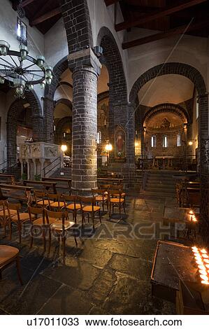 Interior of Romanesque church of San Giacomo showing side nave with stone columns and arches, wooden ceiling and illuminated altar, Bellagio, Lake Como, Northern Italy View Large Photo Image Stock Image - Interior of Romanesque church of San Giacomo showing side nave with stone columns and arches, wooden ceiling and illuminated altar, Bellagio, Lake Como, Northern Italy. Fotosearch