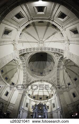 Stock Image - Interior of Santa Maria Maggiore, Rome, showing central nave, baldacchino over altar, coffered ceiling, rich Baroque decoration, and crypt below. Fotosearch