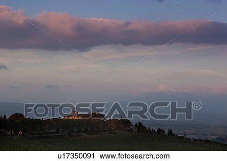 Italian rural abbey at sunset, with spectacular cloud formation, vineyards on sloping hills of foreground View Large Photo Image Stock Image - Italian rural abbey at sunset, with spectacular cloud formation, vineyards on sloping hills of foreground. Fotosearch