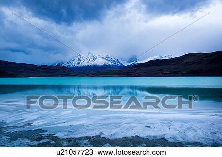Laguna Amarga at sunrise with view of Las Torres reflected in water, sulphur deposits along shoreline, Torres del Paine, Southern Chile, Patagonia View Large Photo Image Stock Image - Laguna Amarga at sunrise with view of Las Torres reflected in water, sulphur deposits along shoreline, Torres del Paine, Southern Chile, Patagonia. Fotosearch