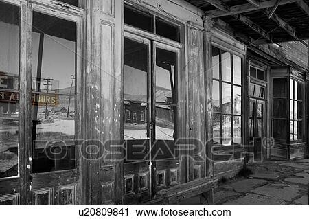 Main hotel doorway with glass abstract reflection of wooden housing, hills and sky in early summer morning, Bodie pioneer village, California View Large Photo Image Stock Image - Main hotel doorway with glass abstract reflection of wooden housing, hills and sky in early summer morning, Bodie pioneer village, California. Fotosearch