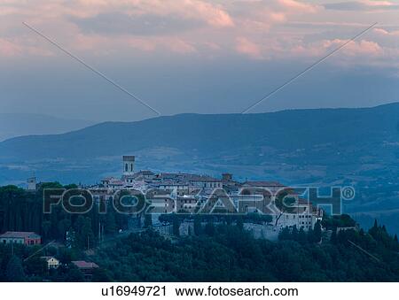 Stock Image - Medieval hilltop town of Monte Castello di Vibio, at sunrise, with pink clouds, skyscape, Umbria, Italy. Fotosearch