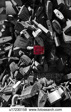 Monochrome close up view of multiple padlocks chained to lamp post, with central padlock in original red colour, inscribed with design of a heart and the message "per sempre" (for always), Italy View Large Photo Image Stock Photo - Monochrome close up view of multiple padlocks chained to lamp post, with central padlock in original red colour, inscribed with design of a heart and the message "per sempre" (for always), Italy. Fotosearch