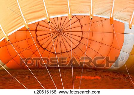 Stock Photograph - Orange interior of balloon, lying on ground, before take-off. Fotosearch
