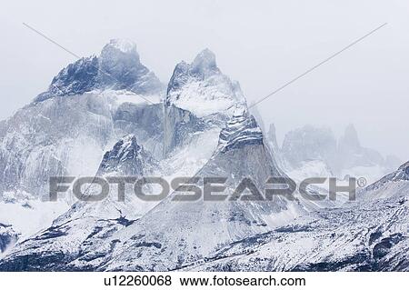 Stock Photo - Panorama monochrome view of snow covered Los Cuernos mountains with dramatic autumn cloudscape, Torres del Paine, Southern Chile, Patagonia. Fotosearch