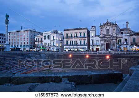 Roman amphitheatre with semicircular arena and foundations in foreground, shops and Baroque facade of church beyond, at dusk, with night illuminations, Lecce, Salento, Puglia, Southern Italy View Large Photo Image Stock Image - Roman amphitheatre with semicircular arena and foundations in foreground, shops and Baroque facade of church beyond, at dusk, with night illuminations, Lecce, Salento, Puglia, Southern Italy. Fotosearch
