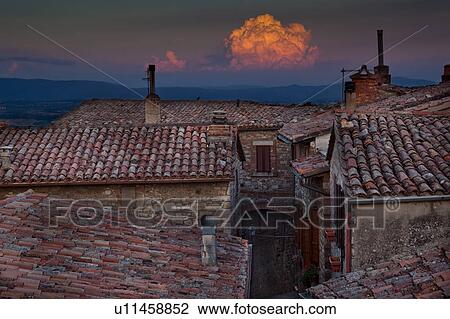 Rooftop view of Italian village street with houses and roof tiles in foreground, and spectacular sunset and hills beyond, Umbria, Italy View Large Photo Image Stock Image - Rooftop view of Italian village street with houses and roof tiles in foreground, and spectacular sunset and hills beyond, Umbria, Italy. Fotosearch
