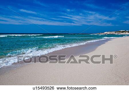 Sandy beach and rolling waves, clear green sea and blue sky, sunny spring morning, Salento, Puglia, Southern Italy View Large Photo Image Stock Photograph - Sandy beach and rolling waves, clear green sea and blue sky, sunny spring morning, Salento, Puglia, Southern Italy. Fotosearch