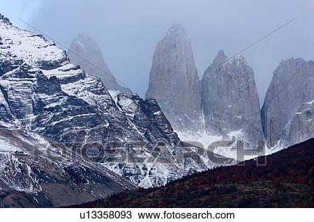 Sunrise view of snow covered Las Torres mountain range, with foreground hills and beech trees with autumn foliage, Torres del Paine, Southern Chile, Patagonia View Large Photo Image Stock Image - Sunrise view of snow covered Las Torres mountain range, with foreground hills and beech trees with autumn foliage, Torres del Paine, Southern Chile, Patagonia. Fotosearch