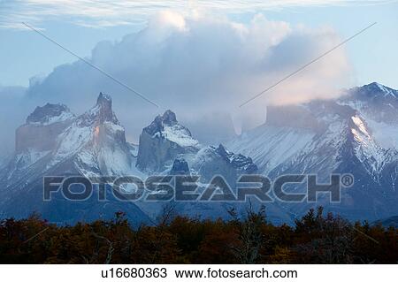 Sunrise view of snow covered Los Cuernos, and Towers, Torres del Paine, with dramatic clouds, beech trees in full autumn colours, River Serrano in foreground, Southern Chile, Patagonia View Large Photo Image Stock Image - Sunrise view of snow covered Los Cuernos, and Towers, Torres del Paine, with dramatic clouds, beech trees in full autumn colours, River Serrano in foreground, Southern Chile, Patagonia. Fotosearch